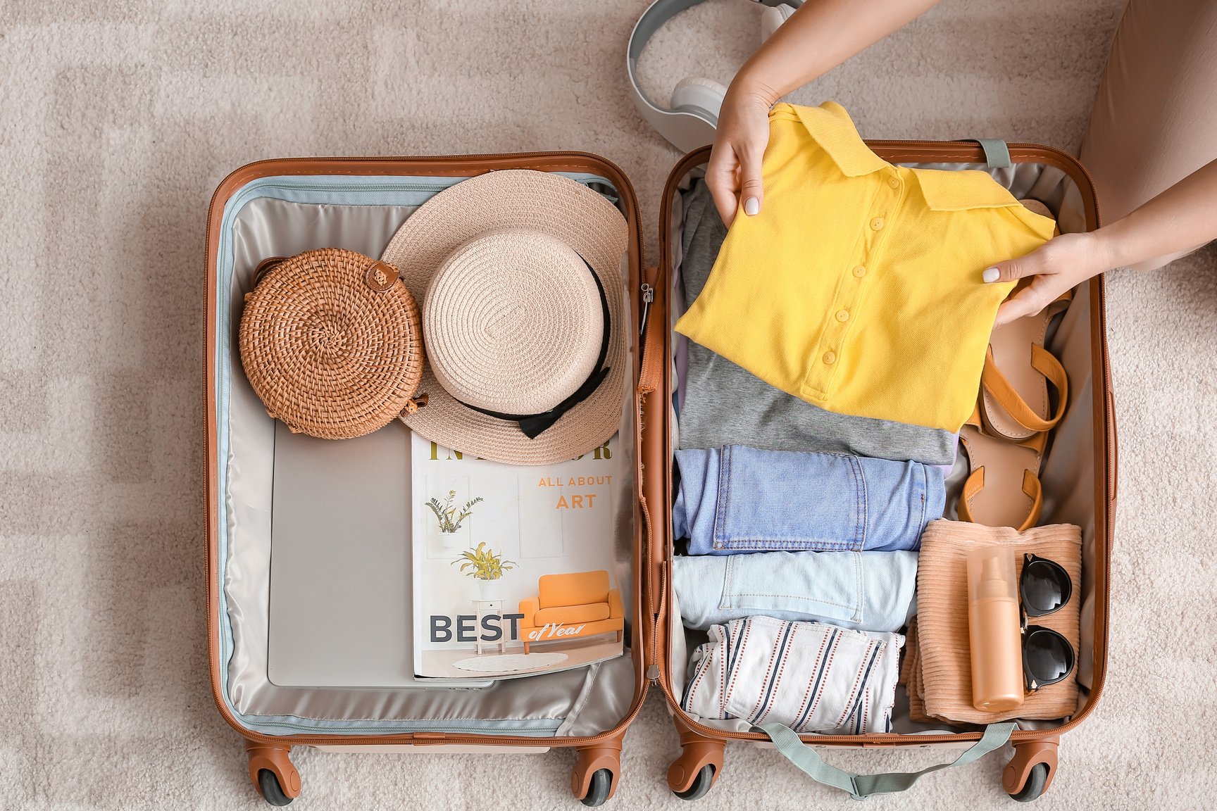 Person Packing Suitcase at Home